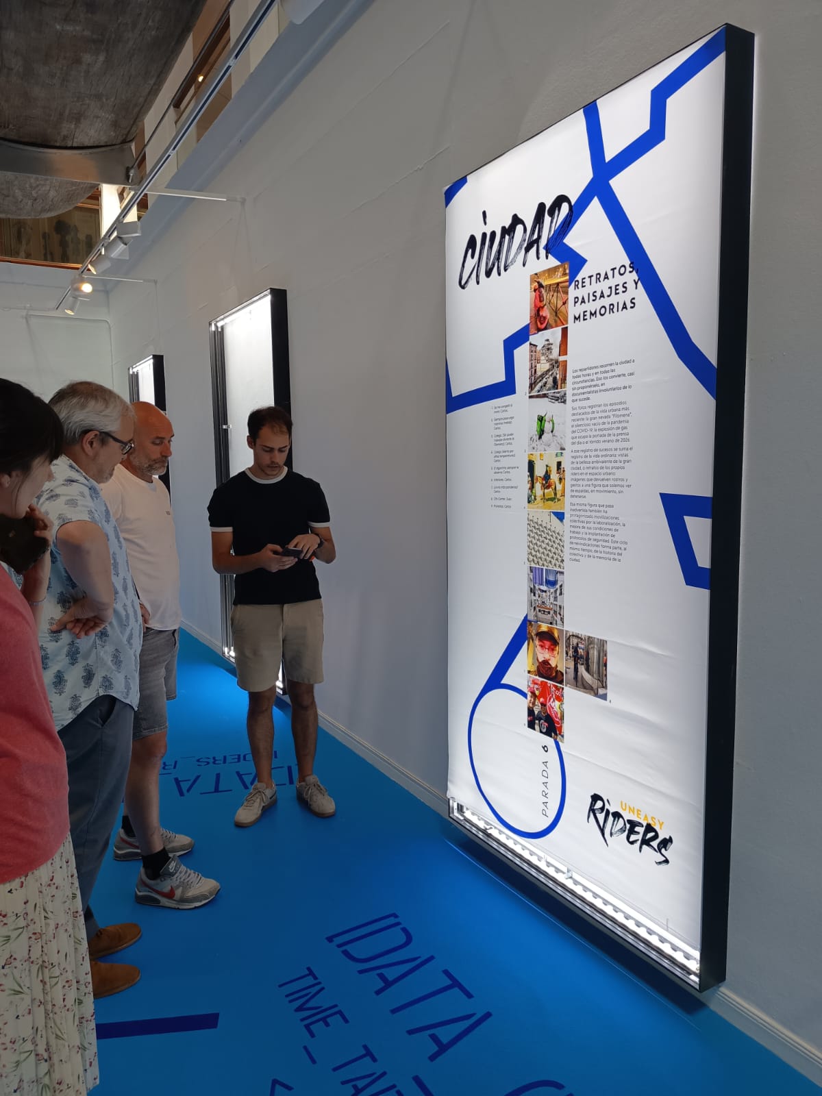 Visitantes ante un panel de la exposición