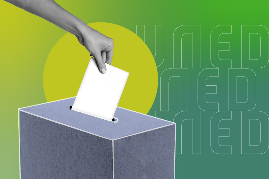 Imagen de una mano introduciendo un voto en una urna